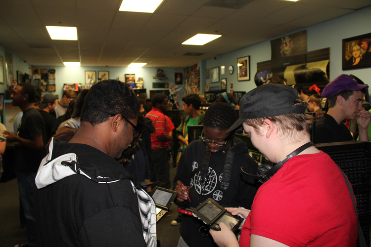 A group of gamers playing on their Nintendo 3DS's